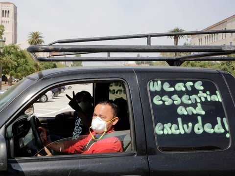 Pasadena day laborers and supporters hold a "COVID-19-safe car rally" to protest what they say is an exclusion of workers from financial protection for essential immigrant workers outside the city hall in Pasadena April 29, 2020.
