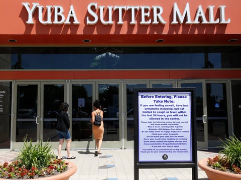 A sign advises shoppers about precautions as they enter the Yuba Sutter Mall in Yuba City, Calif., Wednesday, May 6, 2020.