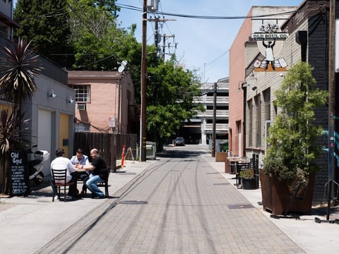 Patrons sit across the alley, far from the entrance to Old Soul in Liestal Alley, one of the cafes and restaurants serving dine-in customers in Sacramento County Friday, May 22, 2020.