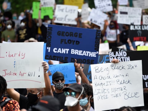 Demonstrators protest in Centennial Olympic Park, Friday, May 29, 2020 in Atlanta. Protests were organized in cities around the United States following the death of George Floyd during an arrest in Minneapolis.