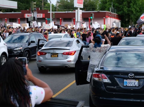 Demonstrators march in Oak Park at a ‘Solidarity With Minneapolis’ in response to the killing of George Floyd.