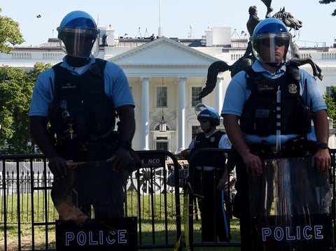 Police hold a perimeter near the White House as demonstrators gather to protest the killing of George Floyd on Monday.