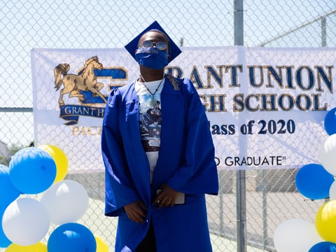 Ezavion Coner poses for a graduation photo with a cloth mask matching his graduation robe Tuesday, June 2, 2020.