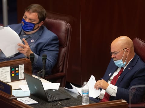 State Sens. James Ohrenschall, left, and Ira Hansen, right, look over papers on the first day of the 31st Special Session of the Nevada Legislature in Carson City, Nev., on Wednesday, July 8, 2020.