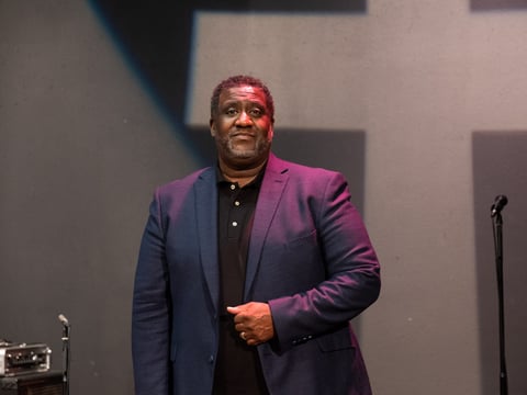 Pictured is Senior Pastor Dr. Tecoy Porter, Sr., standing at the pulpit he delivers his livestreamed sermons at Genesis Church in Sacramento.