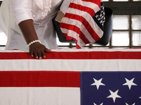 A mourner pauses by the casket of Rep. John Lewis lying in repose at the state capital, Wednesday, July 29, 2020, in Atlanta.