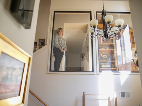 Teresa Pasquini looks into the foyer of her home where her son, who has schizoaffective disorder, once attempted suicide before being discovered by his younger sister.