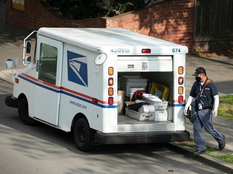 A mail carrier wearing a mask and gloves in Berkeley on March 27, 2020. Postal employees are considered essential during the shelter in place.