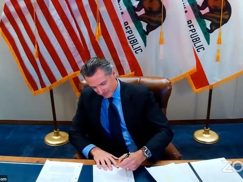 This image made from video from the Office of the Governor shows California Gov. Gavin Newsom signing into law a bill that establishes a task force to come up with recommendations on how to give reparations to Black Americans on Wednesday, Sept. 30.