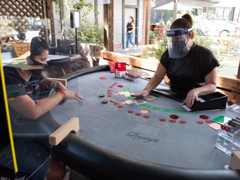 Kathleen Avalos deals blackjack cards to Vanessa Phelps at Limelight in Sacramento Wednesday, Oct. 7, 2020.