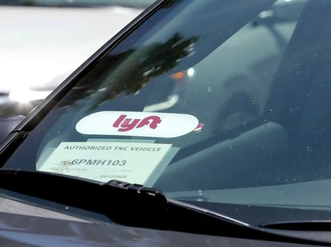 In this July 9, 2019, file photo a Lyft ride-share car waits at a stoplight in Sacramento, Calif.