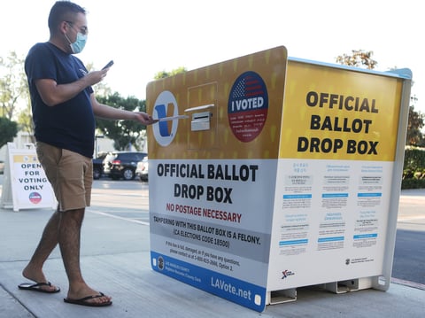 A voter places a ballot in an official mail-in ballot drop box outside of the L.A. County Registrar's office on October 14. The California Republican Party has said it will not comply with a state cease-and-desist order.