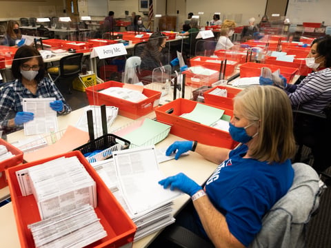 County registrar employees check ballot surfaces and orient them to make sure they scan properly when counted, Tuesday, Nov. 3, 2020.