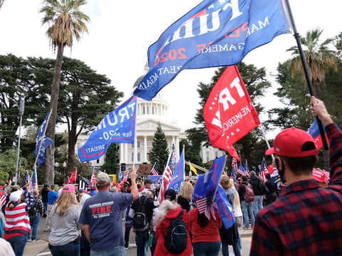 Demonstrators wave flags outside the California Capitol at a pro-Trump rally following the election victory of Joe Biden on Saturday, Nov. 7, 2020.