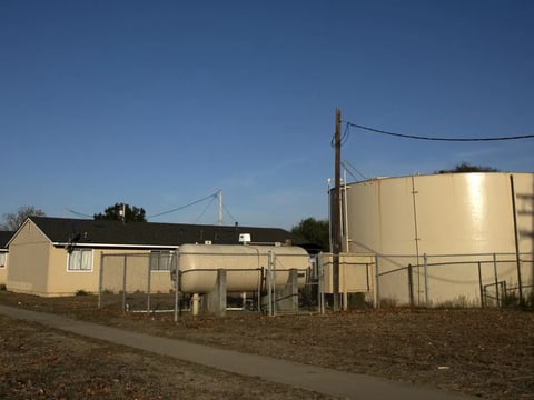 A water tank serving Buena Vista Migrant Center near Watsonville stores water from a well that exceeds state guidelines for a chemical called PFOA. The wells contain levels as high as 13 parts per trillion; the state's new threshold is 10.