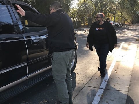 Volunteers direct families picking up turkeys and other food staples at a drive-through event at the Fruitridge Community Collaborative in South Sacramento Nov. 20, 2020.