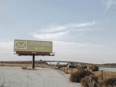 "Simple. Secure. Trustworthy. Counted." A sign reads in Spanish encouraging voters to vote by mail Off I-5 on November 3, 2020.