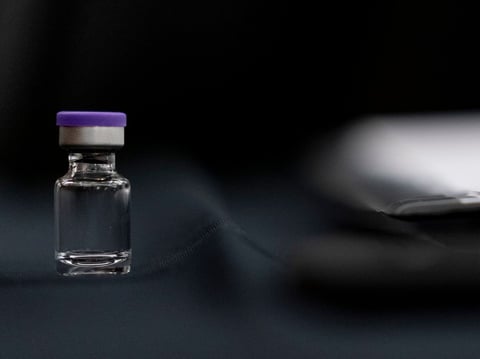 An example of a vial that will carry the COVID-19 vaccine produced by Pfizer and BioNTech sits on display during a Senate subcommittee hearing Thursday.