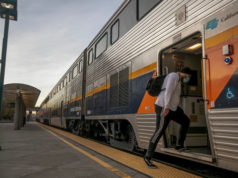 A passenger boards a Bakersfield-bound train at the Emeryville Amtrak station on Dec. 16, 2020.