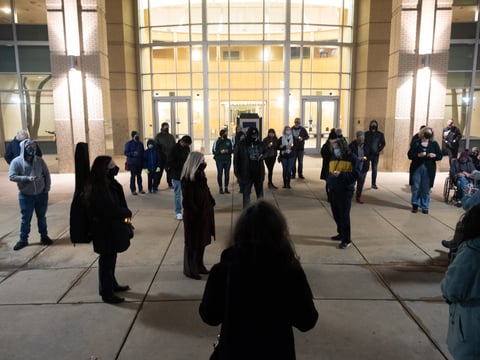 People read out 90 names of unhoused people who have died in Sacramento in 2020 at a memorial at City Hall, Dec. 21, 2020.