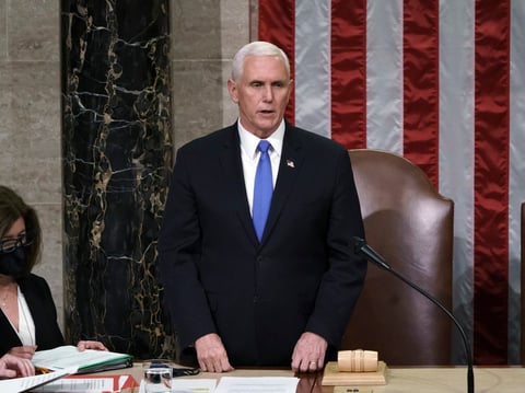 Vice President Pence reads the final certification of Electoral College votes cast in November's presidential election during a joint session of Congress early on Jan. 7.