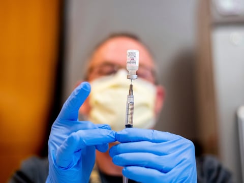 Pharmacist Brian Kiefer draws saline while preparing a dose of Pfizer's COVID-19 vaccine at UC Davis Health on Tuesday, Jan. 12, 2021, in Sacramento, Calif.