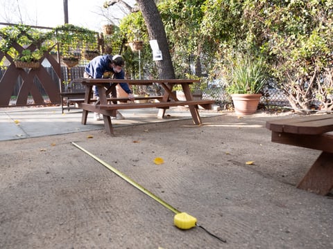 Zach Erickson adjusts tables to ensure they are socially distanced at Hop Garden Wednesday, Jan. 13, 2021.