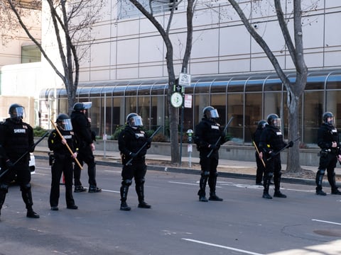 Sacramento Sheriff deputies form a line outside the County Jail during a protest on Wednesday, Jan. 20, 2021.
