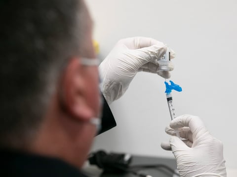 Alameda County health workers prepare syringes with the Moderna COVID-19 vaccine during a distribution clinic at St. Rose hospital in Hayward on Jan. 27, 2021.