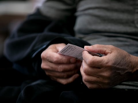 Domingo Comin, an employee at Carefield Assisted Living in Castro Valley, holds his vaccination card. California health officials say they have no plans to develop a state vaccination passport.