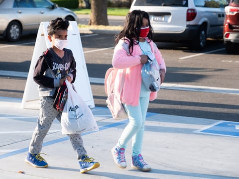 Students arrive at John Cabrillo Elementary school, Thursday, April 8, 2021, for its first day of in-person instruction since distance learning took effect last year.