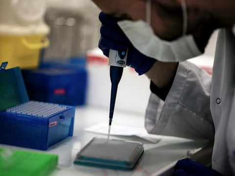 A scientist works on COVID-19 samples to find variations of the virus at the Croix-Rousse Hospital laboratory in Lyon, France, in January.