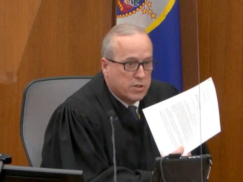 In an image taken from video on Monday, Hennepin County Judge Peter Cahill reads instructions to the jury before closing arguments in the trial of former Minneapolis police officer Derek Chauvin.