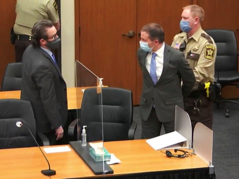 Former Minneapolis police officer Derek Chauvin is taken into custody as his attorney, Eric Nelson, looks on after the verdicts were read on Tuesday at Chauvin's trial for the 2020 death of George Floyd.