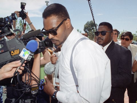Rodney King squeezes past a crush of reporters and photographers after a news conference in Santa Ana, California on Thursday, June 2, 1994
