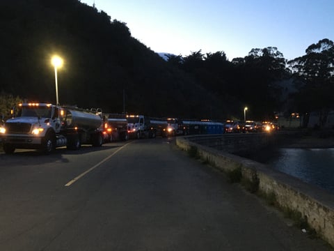 Tanker trucks carrying salmon smolts from CDFW’s Central Valley hatcheries line up at Fort Baker near the Golden Gate Bridge in preparation to release the fish.