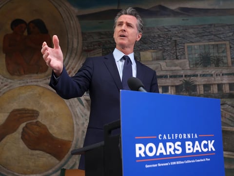 California Gov. Gavin Newsom speaks during a press conference in Oakland, Calif., on Monday where he announced a new round of $600 stimulus checks residents making up to $75,000 a year. Newsom also announced a projected $75.7 billion budget surplus.