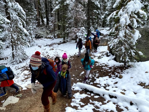 TINS day camp kids hike on a trail near Donner Lake.