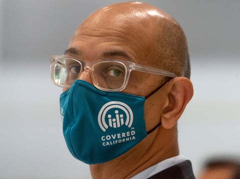 Dr. Mark Ghaly, Secretary of the California Health and Human Service, wears a Covered California facemark as he greets health practitioners working to vaccinate students at the Esteban E. Torres High School in Los Angeles Thursday, May 27, 2021.