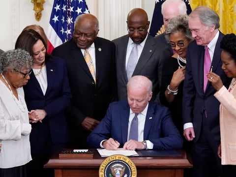 President Joe Biden signs the Juneteenth National Independence Day Act in the East Room of the White House on Thursday.