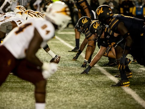 Cal football players line up against ASU on September 27, 2019. Confronted with a California law allowing student athletes to earn money from endorsements, the NCAA has shifted its policy on athlete pay.