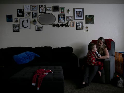 Miranda Griswold cuddles her three-year-old, Rhys, before bedtime at their Merced home on July 8, 2021. “Six weeks is nothing,” Griswold said of the current family leave allotment.