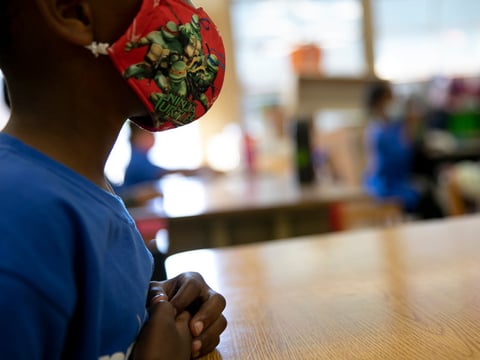 Students wear masks and sit one to a two-person desk in order to social distance during summer classes at Laurel Elementary in Oakland on June 11, 2021.