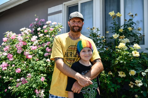 Will Hollman with his son outside of his home in the San Fernando Valley. "I love my kids and it is my duty to be a parent," Hollman said. "I'm fighting a lot of battles."