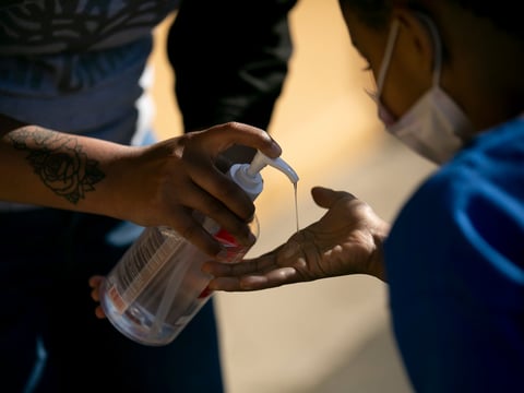 Rising first graders sanitize their hands before entering the classroom during summer session at Laurel Elementary in Oakland on June 11, 2021.