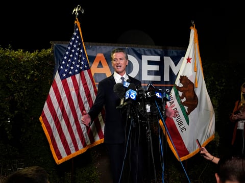 California Gov. Gavin Newsom addresses reporters after beating back the recall attempt that aimed to remove him from office, at the John L. Burton California Democratic Party headquarters in Sacramento, Calif., Tuesday, Sept. 14, 2021.