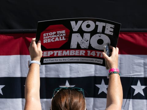 A Gavin Newsom supporter holds up a sign against the recall at a campaign event at the IBEW-NECA training center in San Leandro on Sept. 8, 2021.