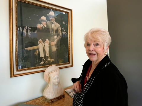 Diane Capone discusses her family near a photograph of her father, Albert "Sonny" Capone, as a young boy and her grandfather Al Capone on display at Witherell's Auction House in Sacramento, Calif., Wednesday, Aug. 25, 2021.