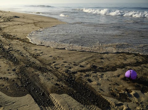 Oil is seen on the beach in Huntington Beach, California on October 3, 2021, after a pipeline breach connected to an oil rig off shore started leaking oil, according to an Orange County Supervisor.