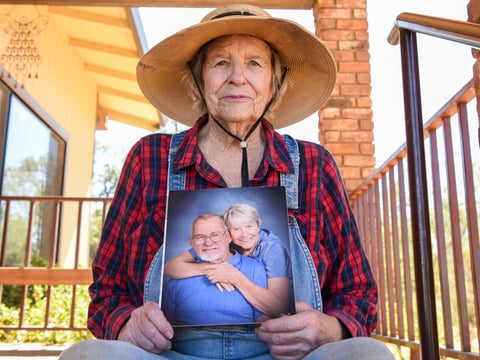 Johanna Trenerry of Happy Valley holds a photograph of herself with her husband, Art Trenerry, who died last year of COVID-19 while staying at Windsor Redding Care Center.